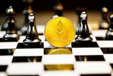 etherium coin sitting on chess board