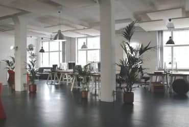 large office space furnished with desks, lights, and chairs