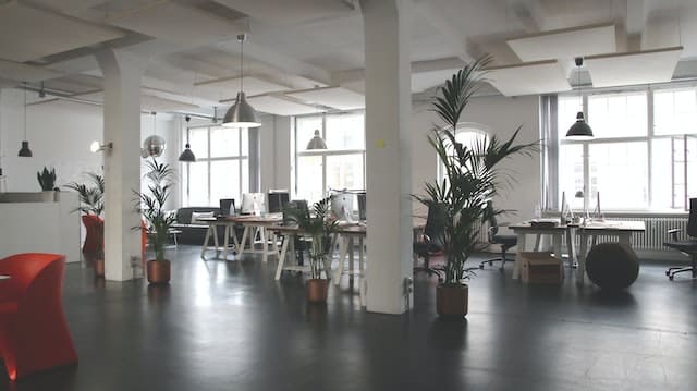 large office space furnished with desks, lights, and chairs