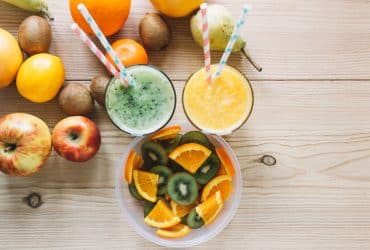 ingredients used to make fruit smoothies shown in a glass