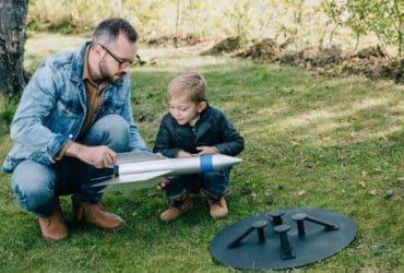 father and son working together on a model rocket