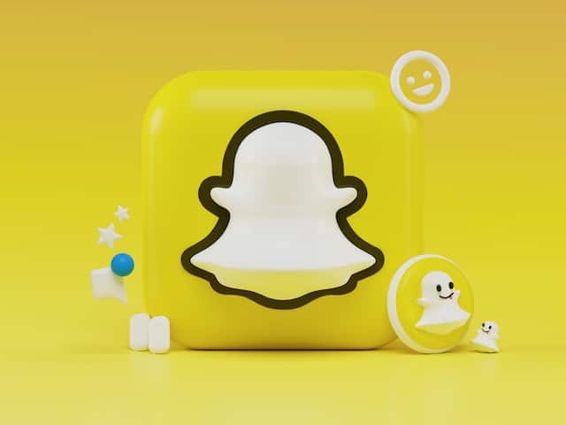 illustration with the snapchat icon and other related icons and emojis