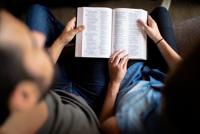 a couple reading together from the Bible
