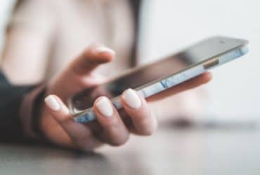 woman's hand holding a smartphone