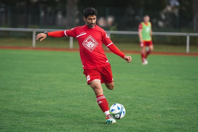 football player in the middle of a power kick