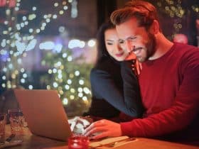man and woman looking at something on a laptop