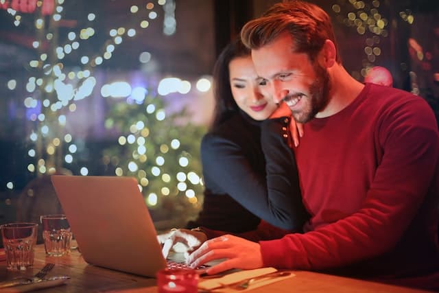 man and woman looking at something on a laptop