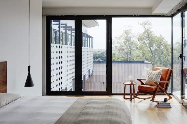 sliding glass door exiting from a bedroom with hardwood floors