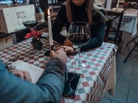 couple holding hands on the table while on a dinner date