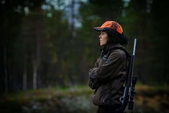 female hunter wearing a blaze orange cap