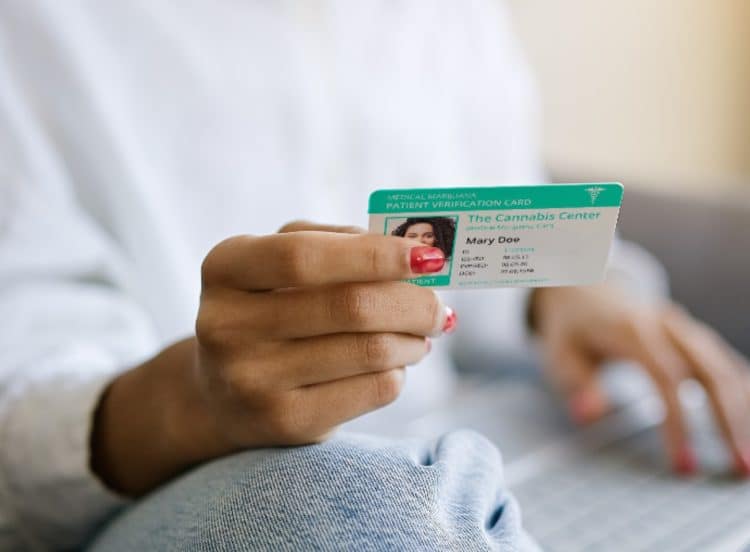 woman looking at her medical marijuana ID card