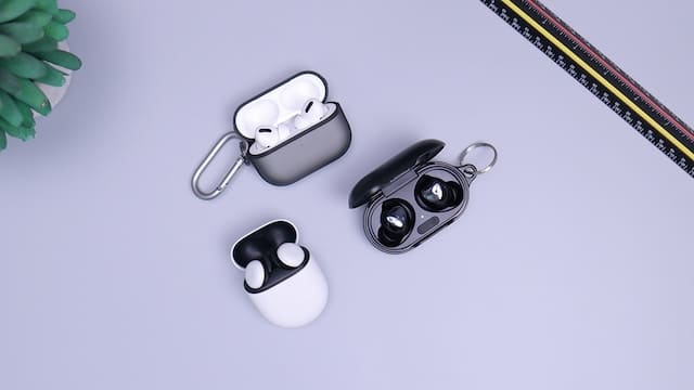 examples of wireless earbuds with a ruler along side them for size comparison