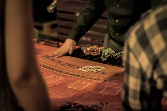black jack table, with dealer showing two queens