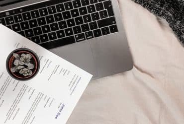 a resume sitting on top of a laptop