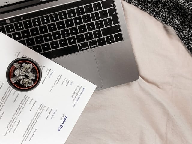 a resume sitting on top of a laptop