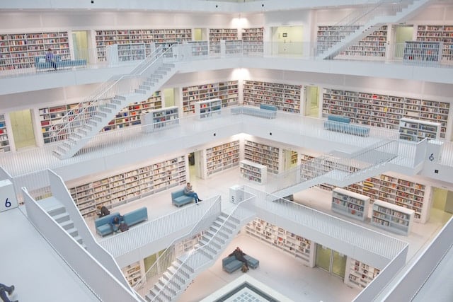 huge library with multiple floors and benches for reading