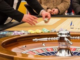 people playing at a roulette table