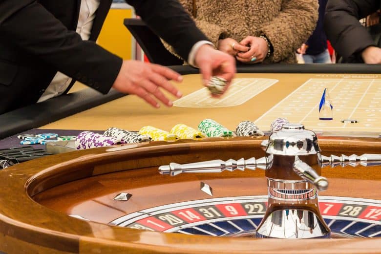 people playing at a roulette table