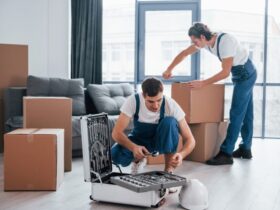 two young men packing boxes for moving