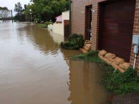 exterior of a house flooded and using sandbags