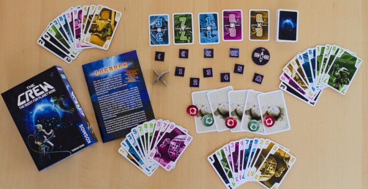 The Crew card and board games laid out on a table