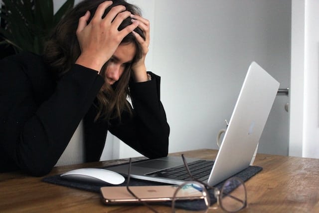 frustrated woman working on laptop