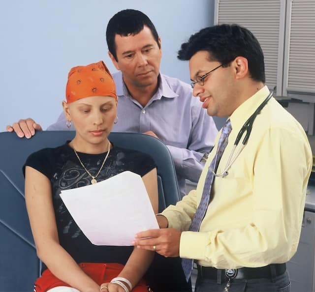 cancer patient reviewing health data with doctor