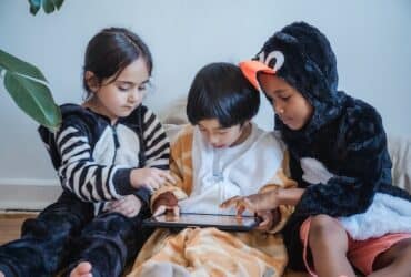 children working together on a tablet
