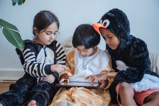 children working together on a tablet