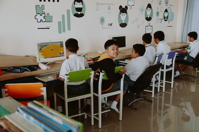 children learning on computers in school
