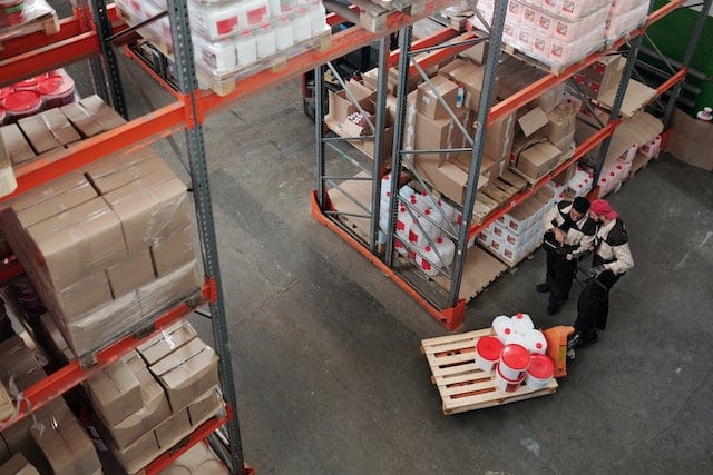 men talking on a warehouse floor