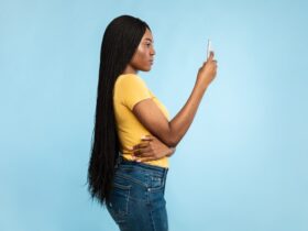 black woman looking into her smartphone