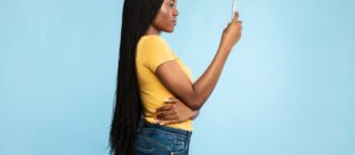 black woman looking into her smartphone