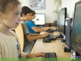 children at computers in school playing a typing game