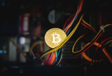 Bitcoin laying on a group of colorful wires