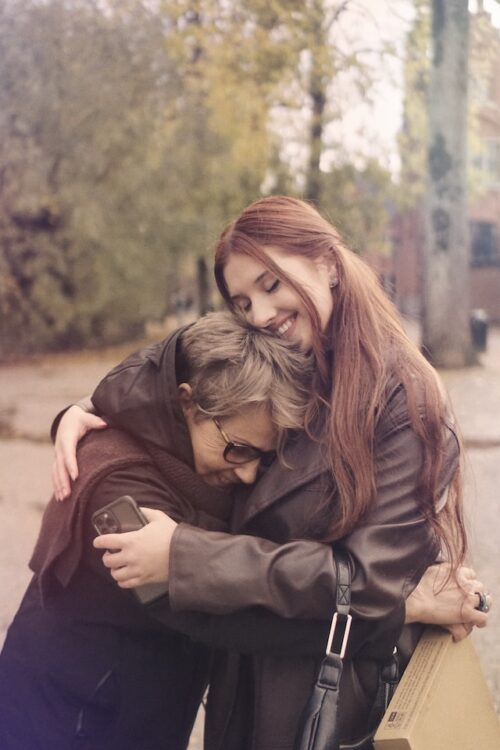 a young woman hugging her elderly grandmother