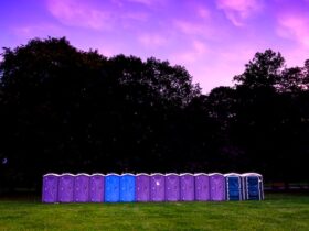 a row of porta potty units set up for an outdoor event