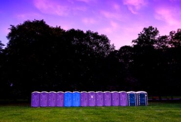 a row of porta potty units set up for an outdoor event