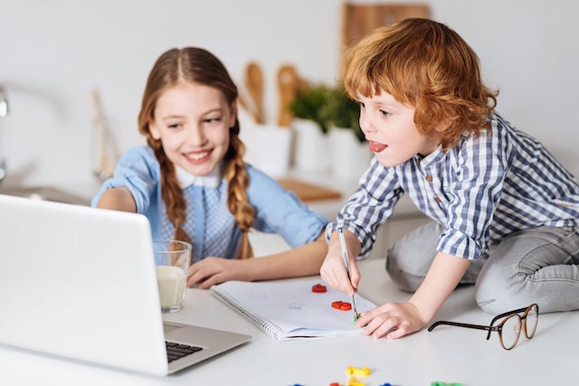 two kids playing a computer game