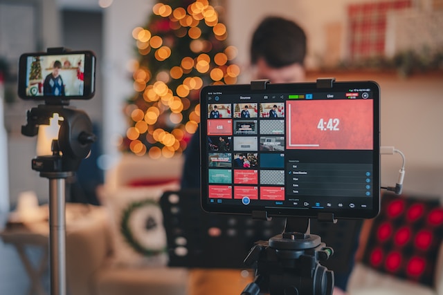 A man livestreaming with a iPhone and iPad