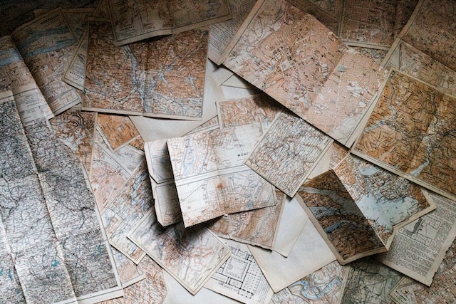 A variety of maps opened on a table