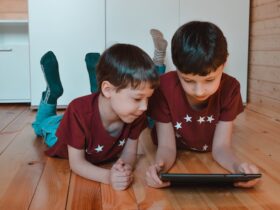 brothers using a tablet on the floor at home