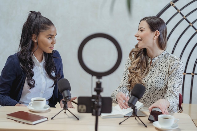 one woman interviewing another woman on a podcast