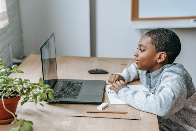 boy playing a game on a laptop