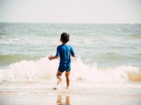 boy running into the waves at a beach