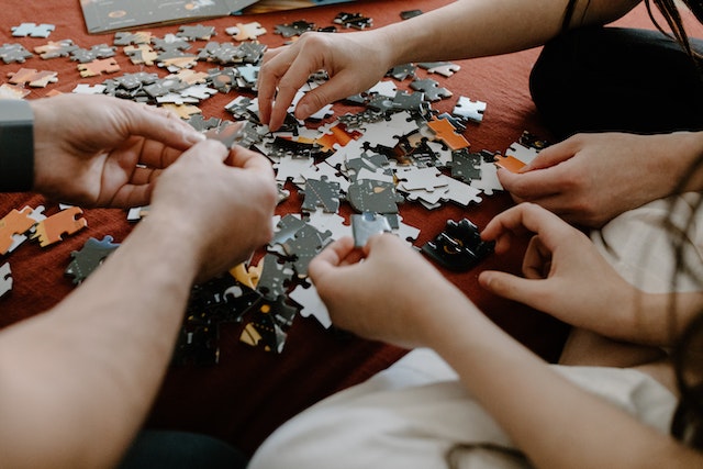 a family working on a jigsaw puzzle together