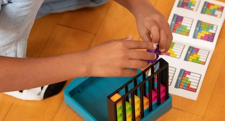 a child playing an upright version of Kanoodle