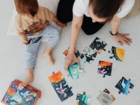 mother and child playing with a puzzle on the floor