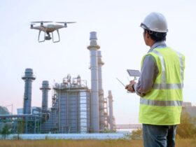 man using a drone to inspect large industrial towers