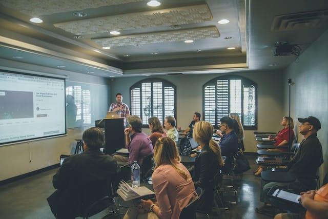 A group of adult learners sitting in a classroom